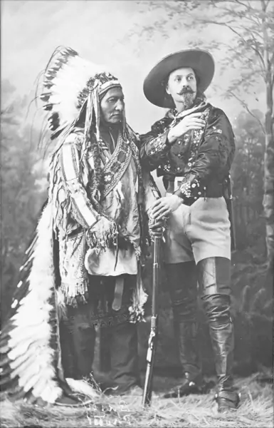 a black and white photo of buffalo bill cody with chief sitting bill who played himself in Buffalo Bill's West Show