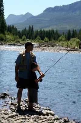 Lance Bower teaching son to fly fish